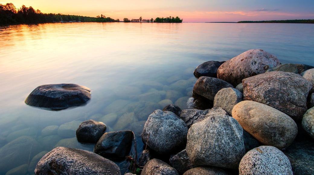 Large boulders on lake shore at sunset. Minnesota, USA