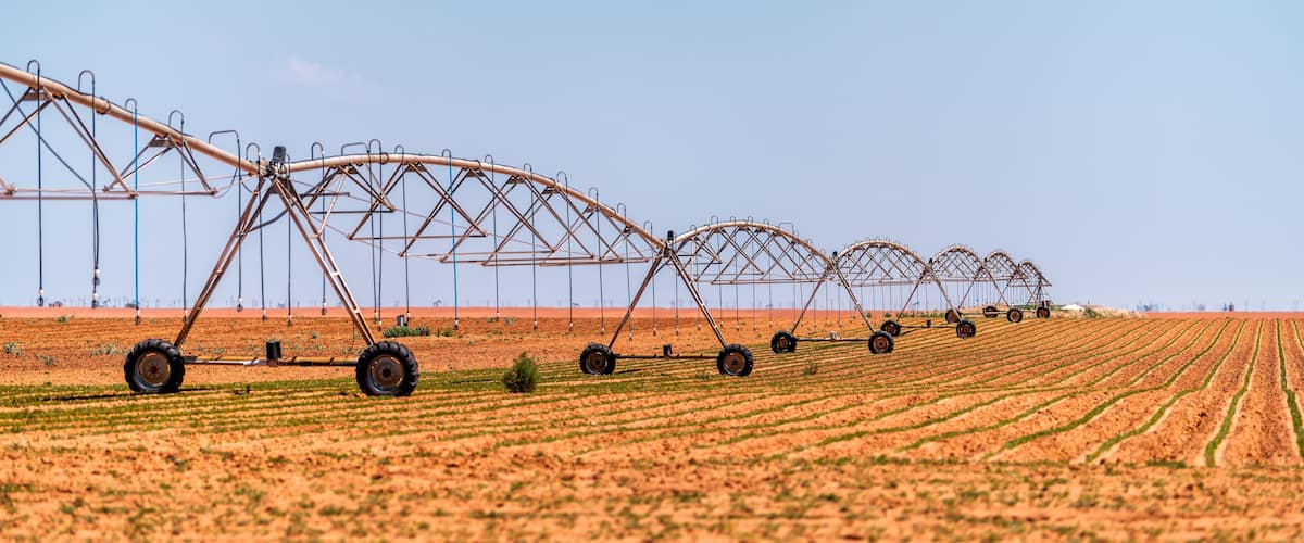 Brownfield, USA Texas rural countryside industrial field with water or fertilizer chemicals sprayer on dry land
