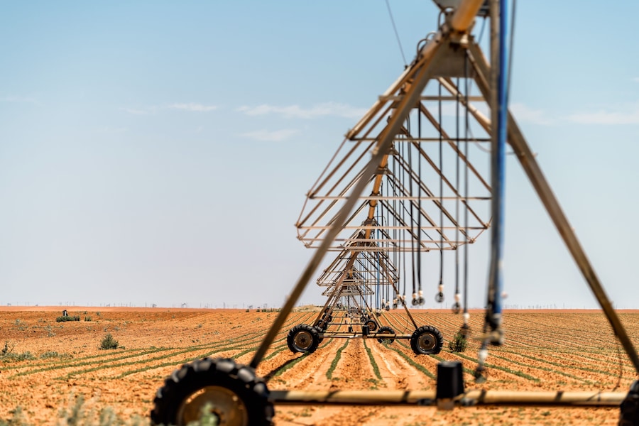 A large agricultural irrigation system in a vast field.