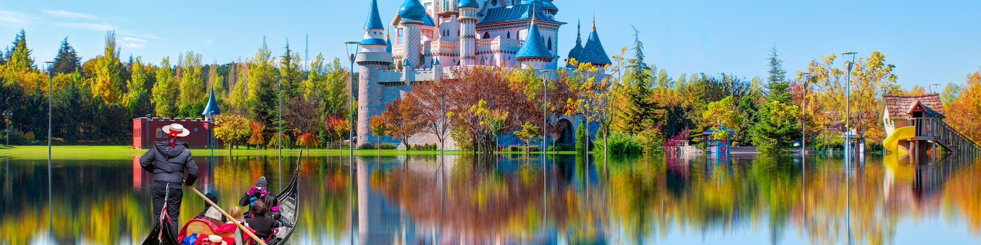 Gondolier punting gondola through canal - Sazova Park with reflection - Eskisehir, Turkey