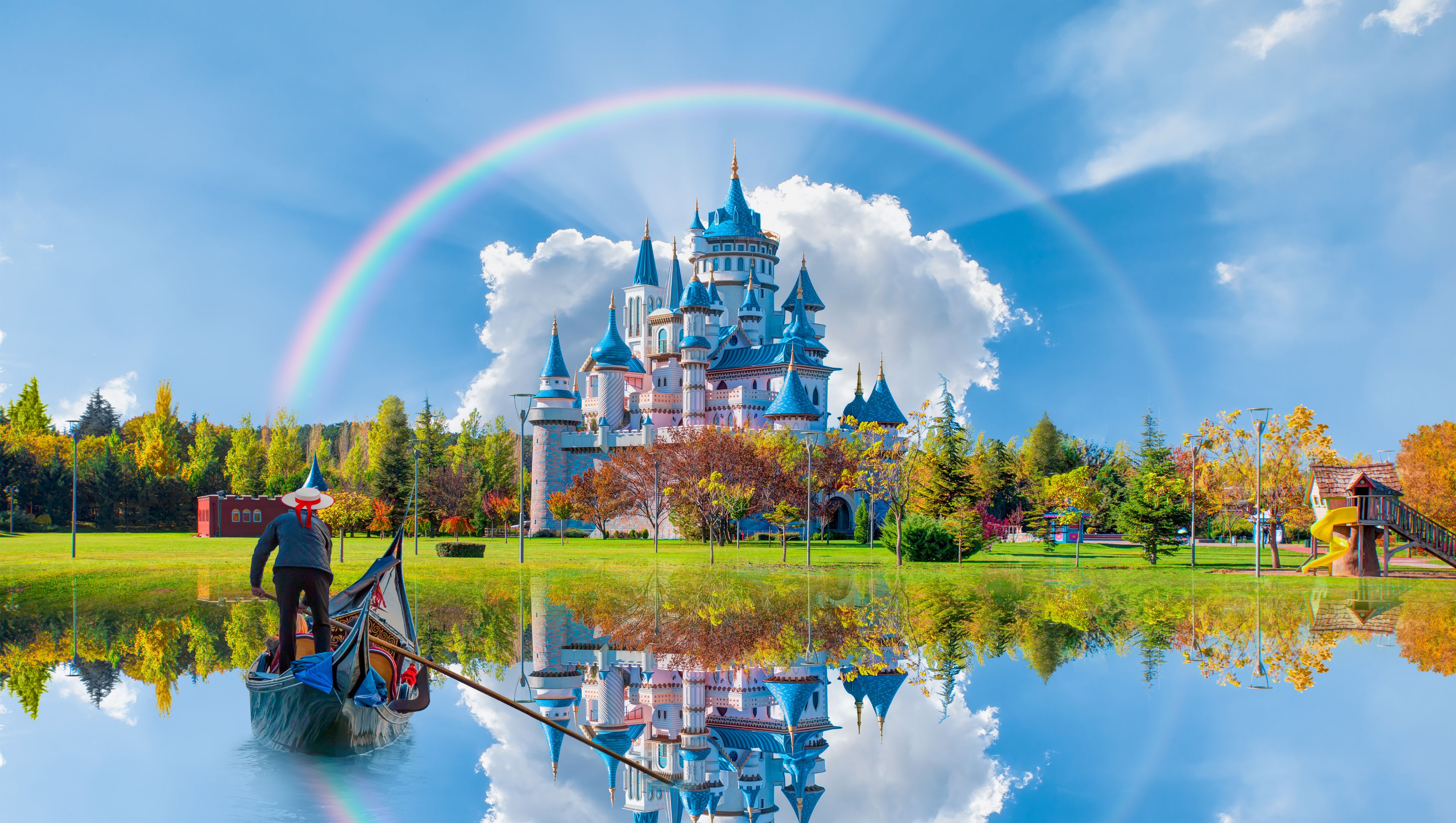 Un château doté de nombreuses tours, un arc-en-ciel et son reflet dans l’eau.