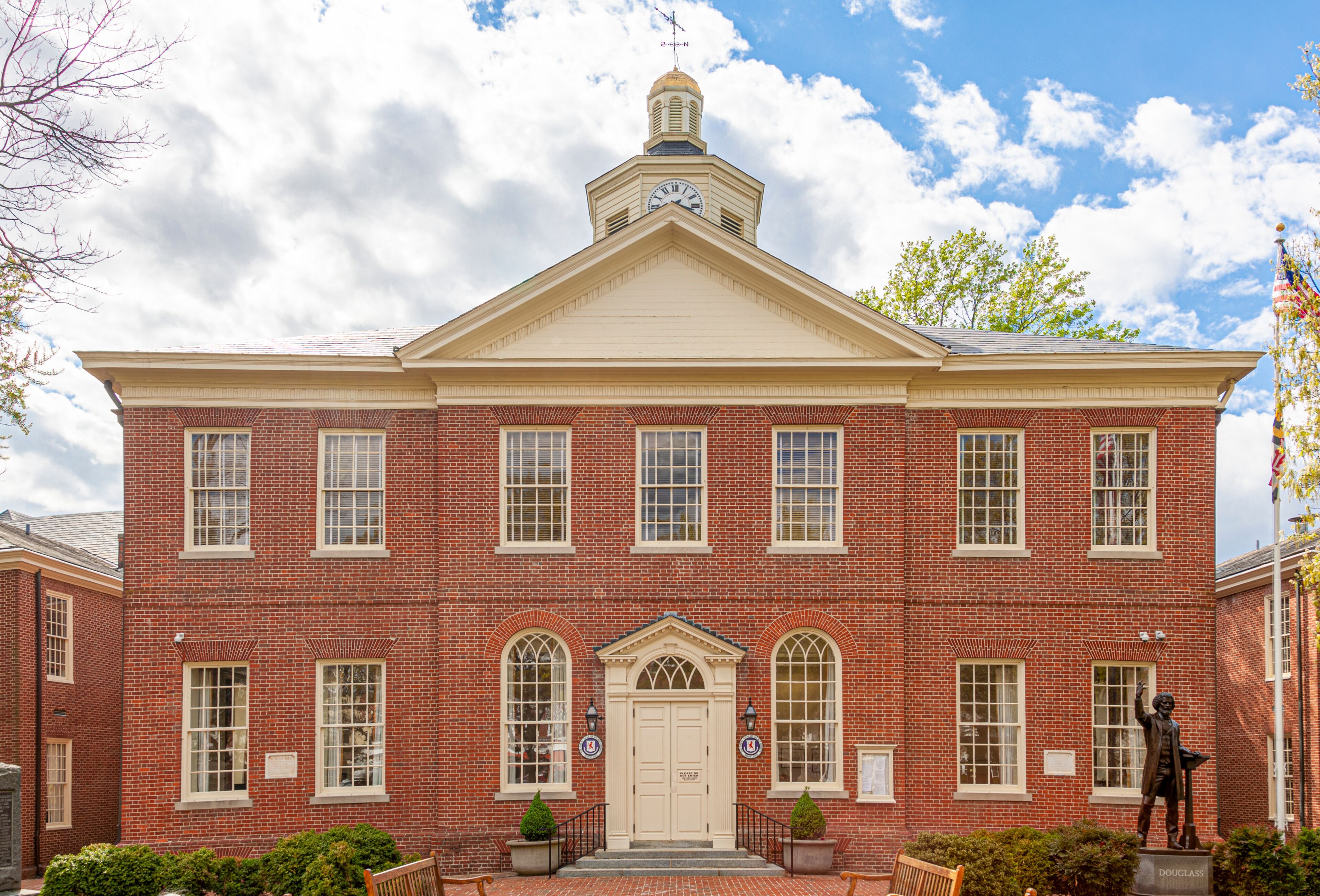 Easton ,MD, USA 04-16-2021: historic Courthouse building is among the oldest landmarks in the beautiful small town of Easton. Brick building has Talbot County Seals on both side of the entrance door.
