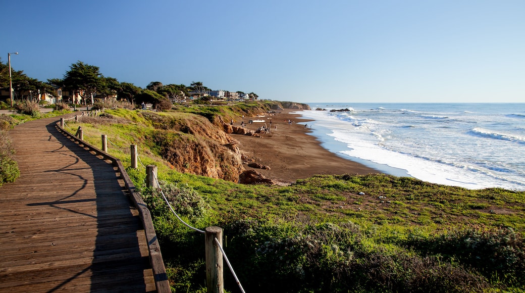 Moonstone Beach in California with wooden walkway along the beach at midday.