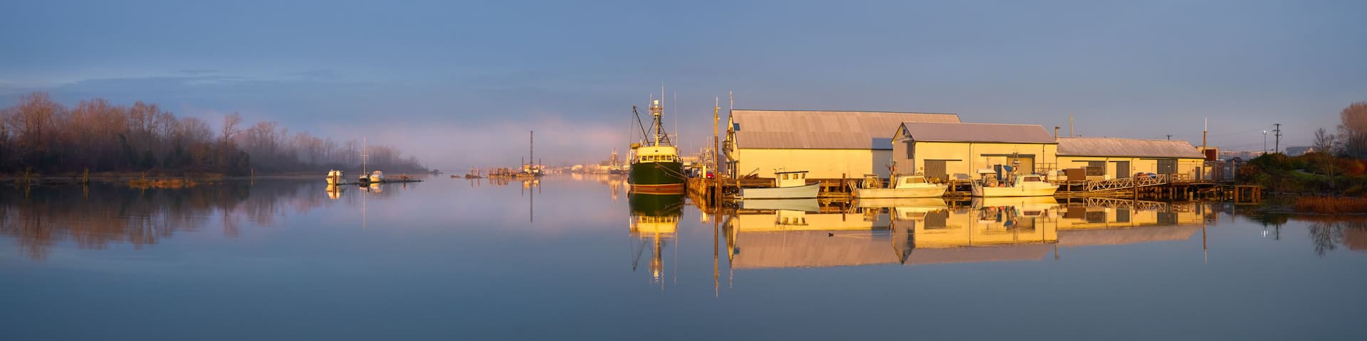 London Landing Sunrise Light Morning Docks. Commercial Fishboats tied to the docks at London Landing in Steveston Harbour on a misty sunrise morning at high tide.