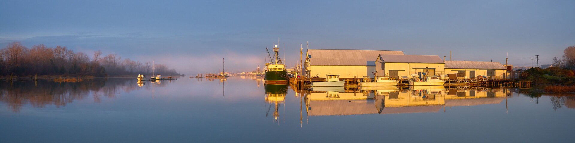 London Landing Sunrise Light Morning Docks. Commercial Fishboats tied to the docks at London Landing in Steveston Harbour on a misty sunrise morning at high tide.