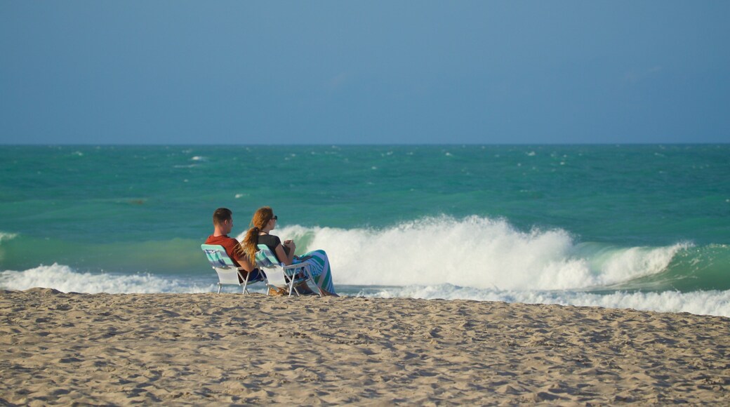 Vero Beach showing a sandy beach and general coastal views as well as a couple