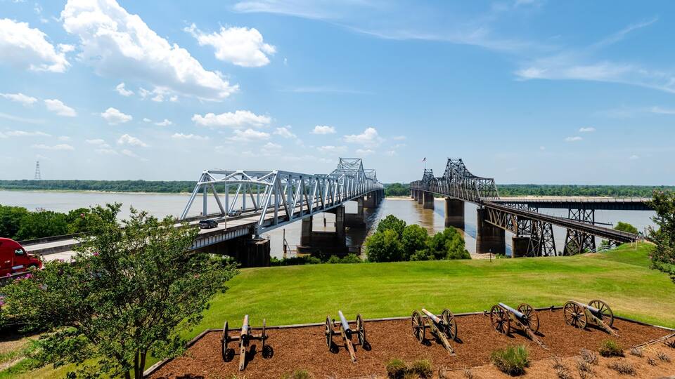 Panorama row of canons display at historic Vicksburg battlefield overlooking twin old new bridges across Mississippi River, artillery during siege of civil war, Mississippi, USA