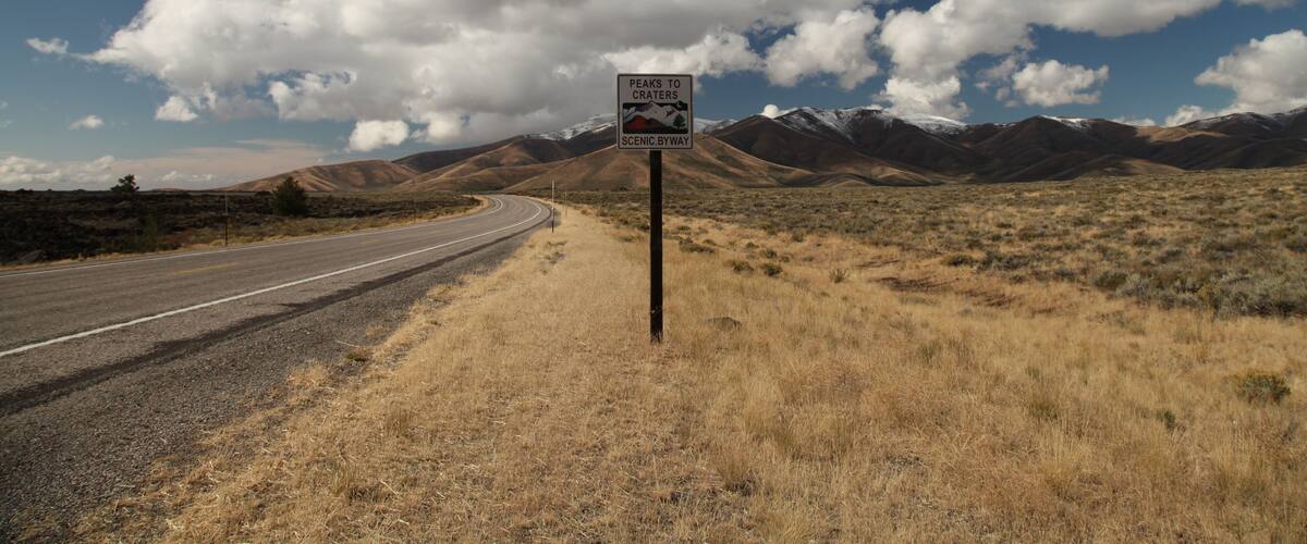 Sign for Peaks To Craters Scenic Byway along the highway in Craters Of The Moon National Monument and Preserve, Idaho; Shutterstock ID 757251226; purchase_order: SP-2792; Order: ; client: ; job: Q1 Sc