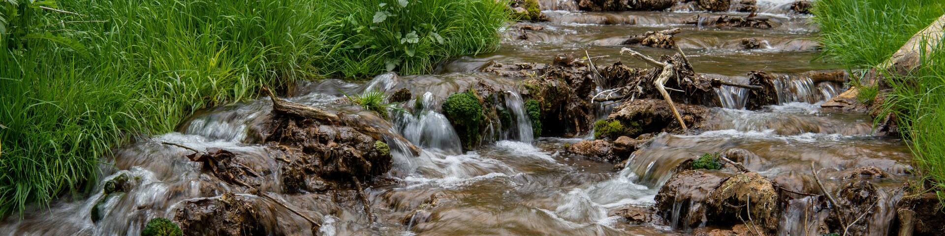 A short little creek is cascading out of the Dunning's Springs Park in Decorah along the Driftless Area Scenic Byway in Iowa, USA