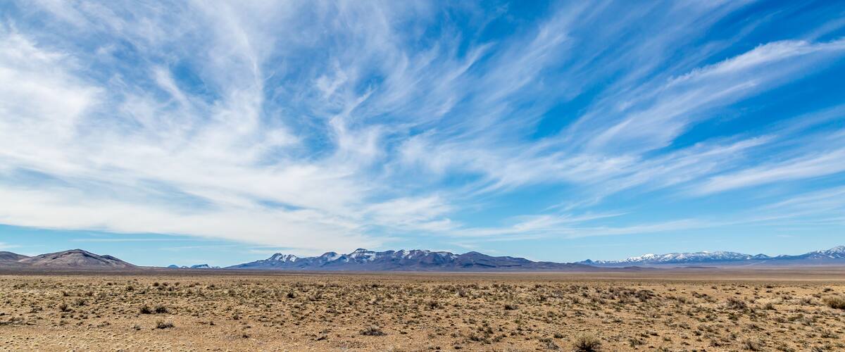 Wispy clouds over a vast desert landscape, along the Extraterrestrial Highway in Nevada