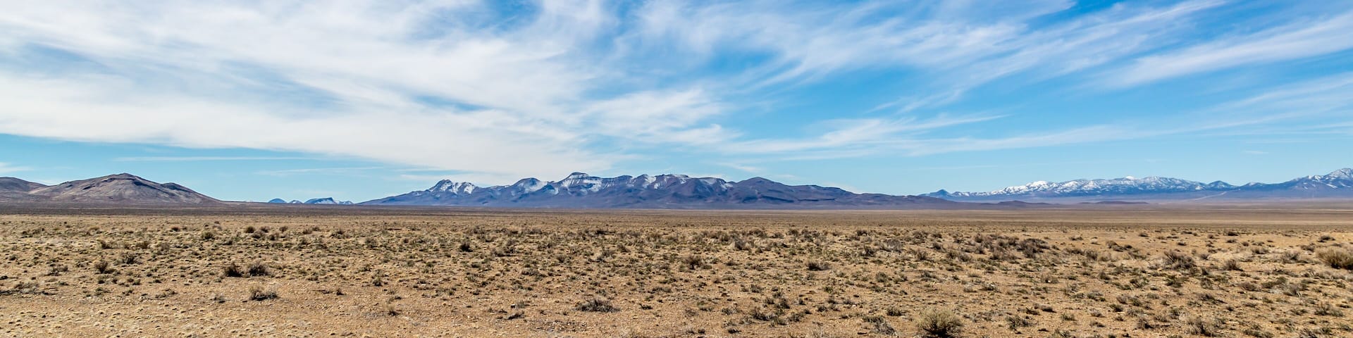 Wispy clouds over a vast desert landscape, along the Extraterrestrial Highway in Nevada