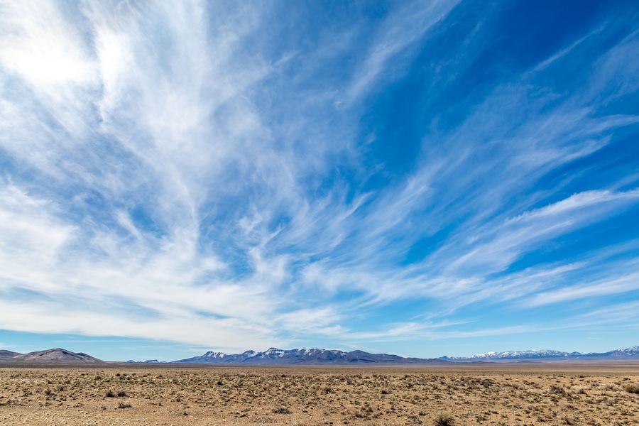 Wispy clouds over a vast desert landscape, along the Extraterrestrial Highway in Nevada