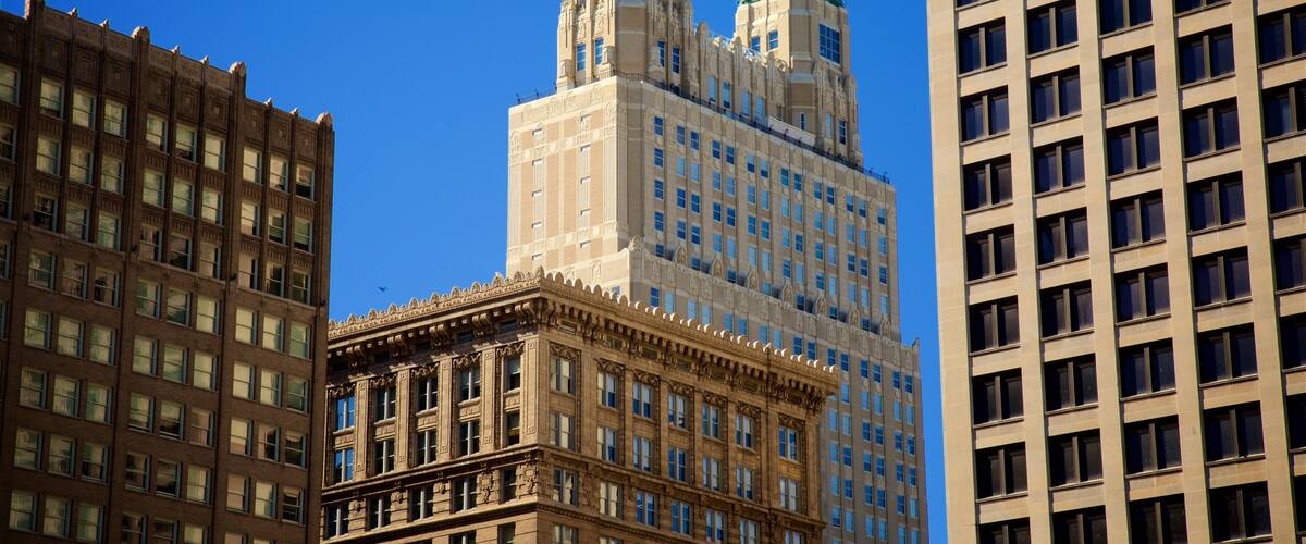 A historic building with ornate architecture and two green-roofed towers.