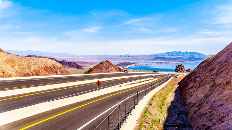 Highway 93 as it dips down to the Mike O' Callaghan-Pat Tillman Memorial Bridge over the Colorado River at the Hoover Dam on the border of the states of Nevada and Arizona
