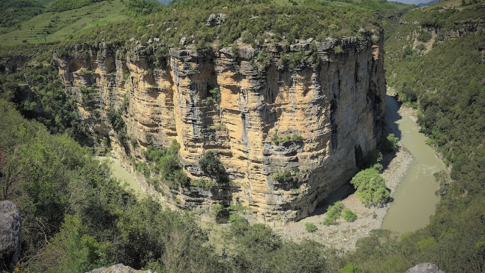 A canyon with steep cliffs and a river.
