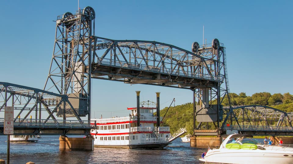 A river with a bridge and a boat.