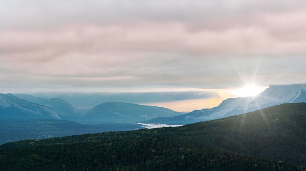 A mountainous landscape with a valley and a lake.
