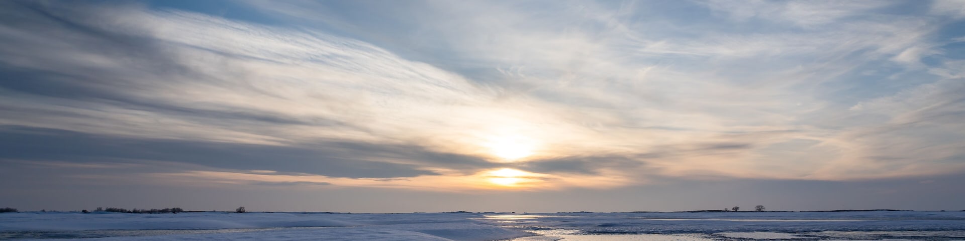 Ice reflection on a frozen lake at sunset in Newell County Alberta Canada.