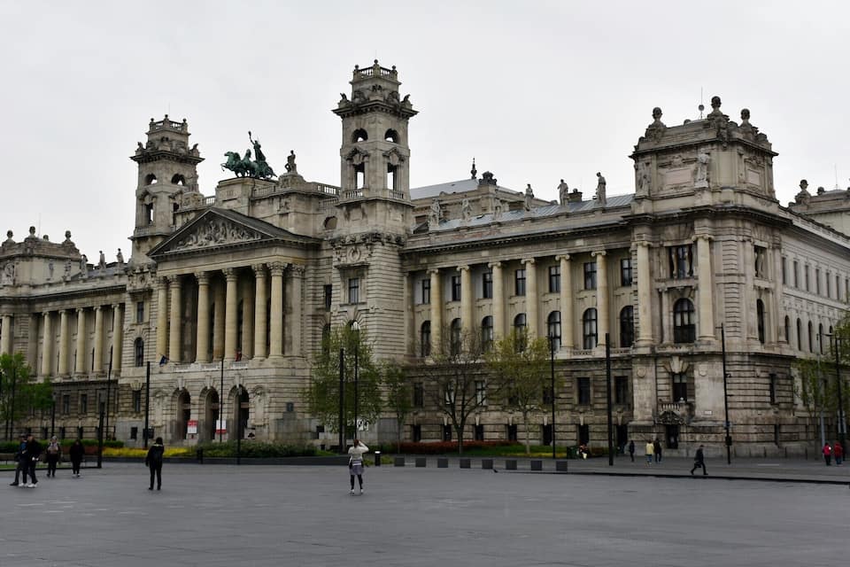 A grand neoclassical building with multiple towers and statues.