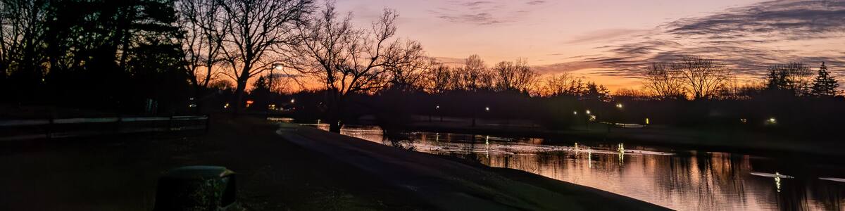 Sunset over the pond at the Northfield Hills Condo association at the corner of Long Lake Road and Coolidge Highway in Troy, Michigan, a suburb of Detroit partly cloudy winter day