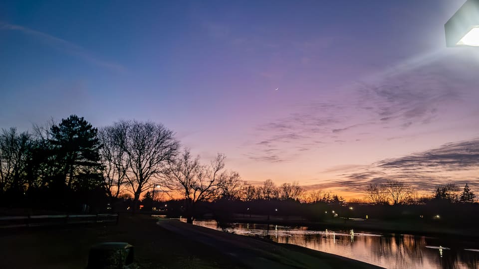 Sunset over the pond at the Northfield Hills Condo association at the corner of Long Lake Road and Coolidge Highway in Troy, Michigan, a suburb of Detroit partly cloudy winter day