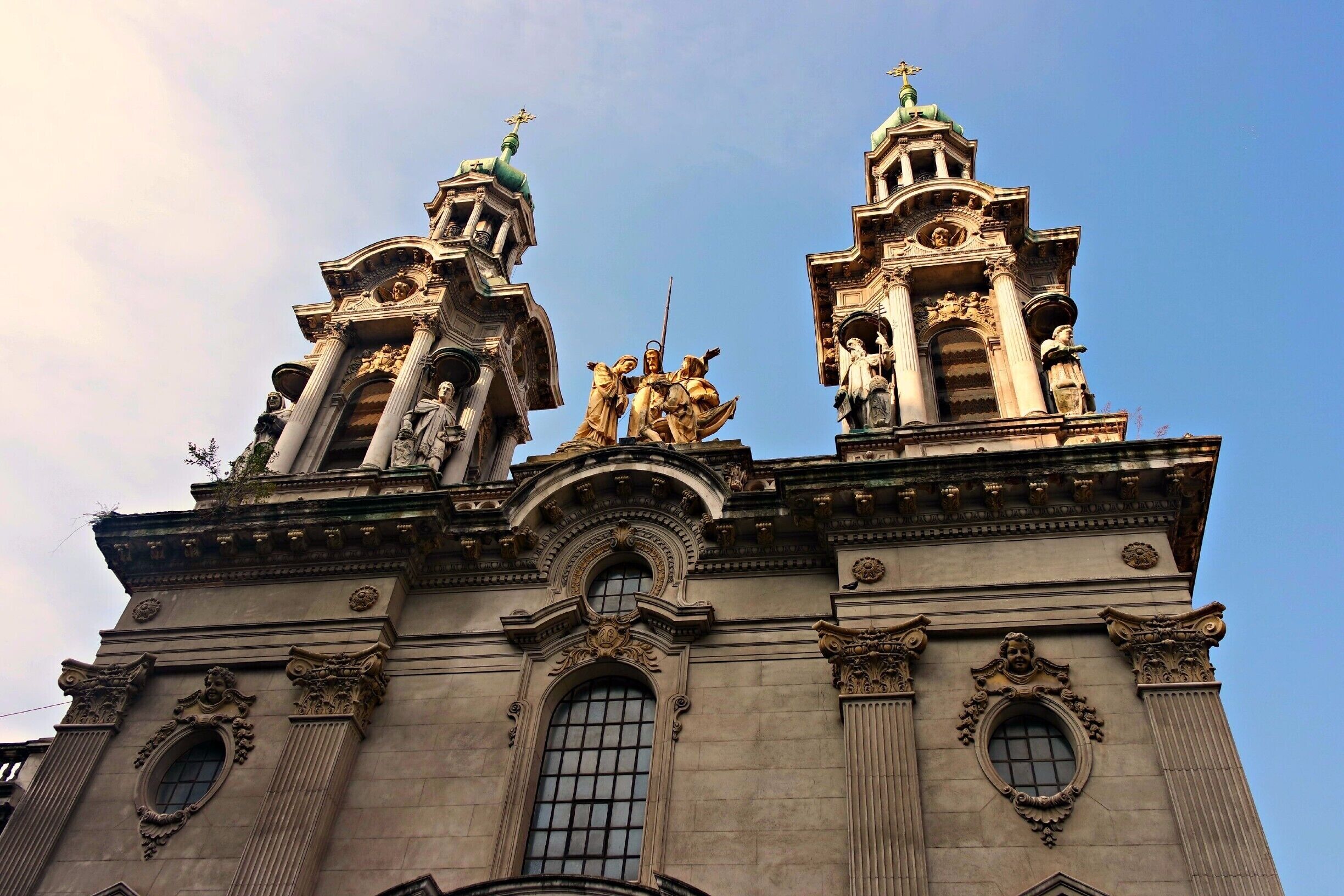 A historic building with ornate architecture, including statues and columns.