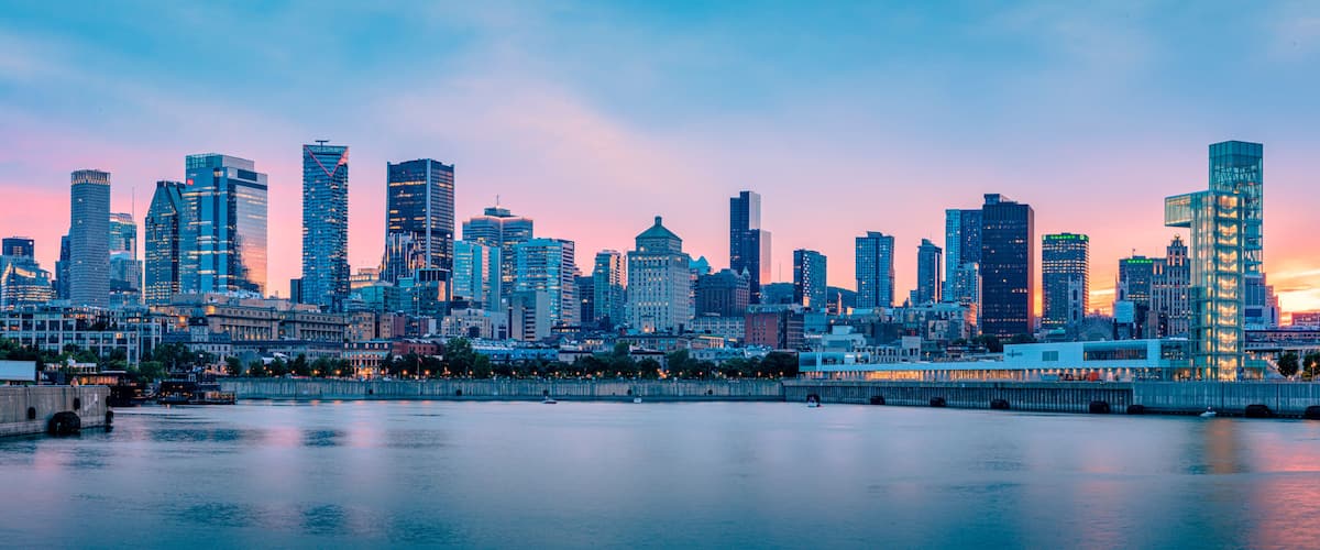 Panoramic view of the Montreal skyline at dusk from the Old Port, downtown skyscrapers along the Saint Lawrence River waterfront, Quebec, Canada