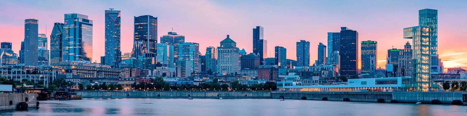 Panoramic view of the Montreal skyline at dusk from the Old Port, downtown skyscrapers along the Saint Lawrence River waterfront, Quebec, Canada