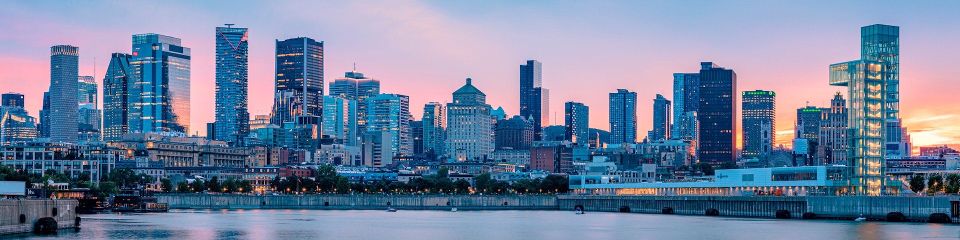 Panoramic view of the Montreal skyline at dusk from the Old Port, downtown skyscrapers along the Saint Lawrence River waterfront, Quebec, Canada