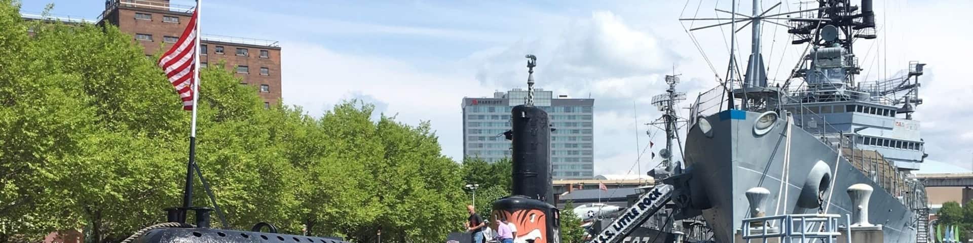 Marina with couple planes, Submarines, Attack boats, and other military ships. Can also get a tour of some of the ships for a price. Great for a walk on a hot day as you feel a breeze from the water. Also a large field along marina filled with wooden lawn chairs to relax in and enjoy.