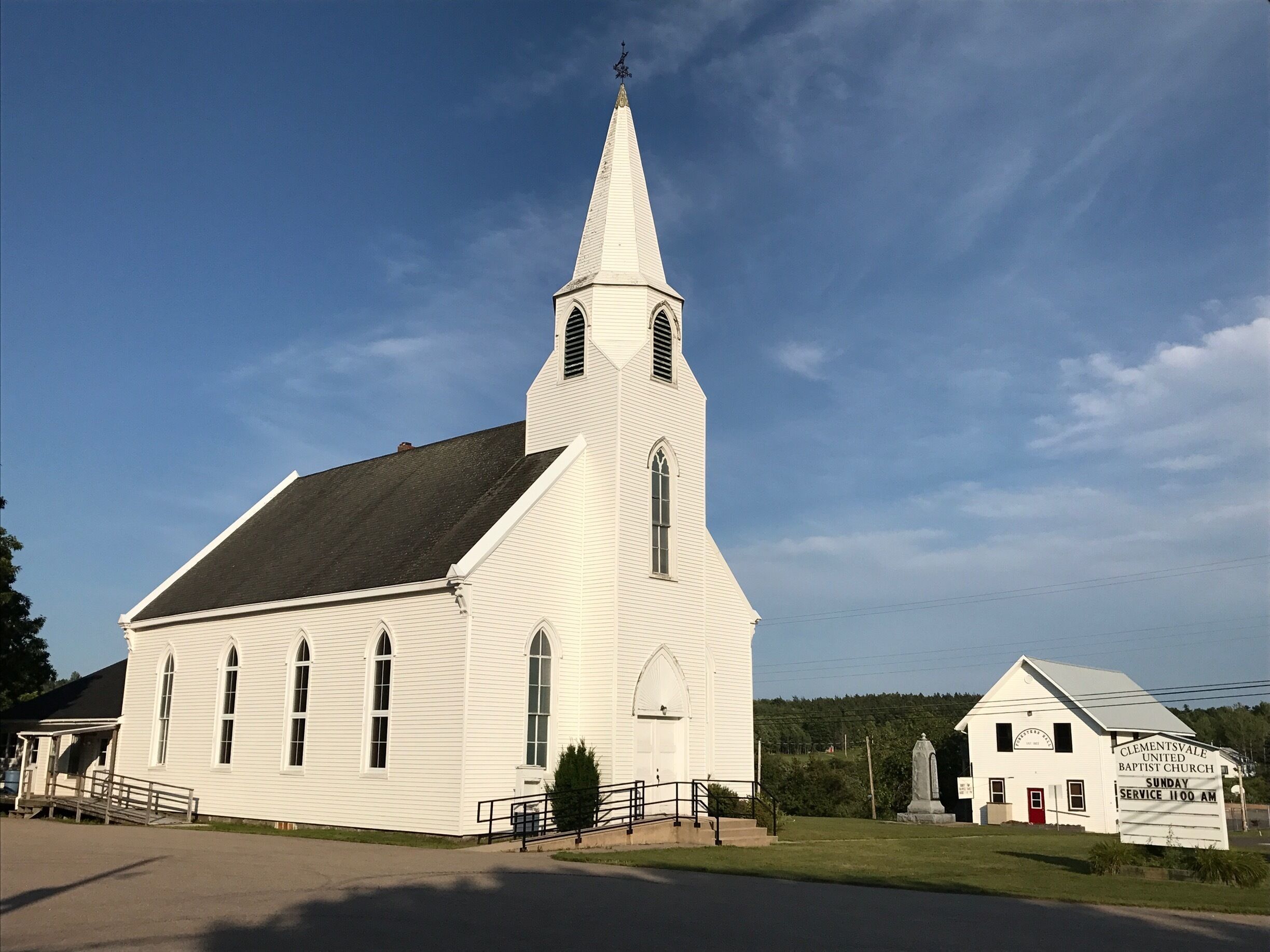 A white church with a steeple and a smaller building labeled "Clementsville Baptist Church".