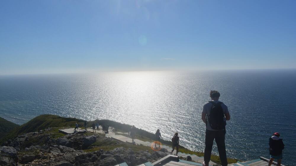 A coastal viewpoint with a wooden walkway overlooking the sea.