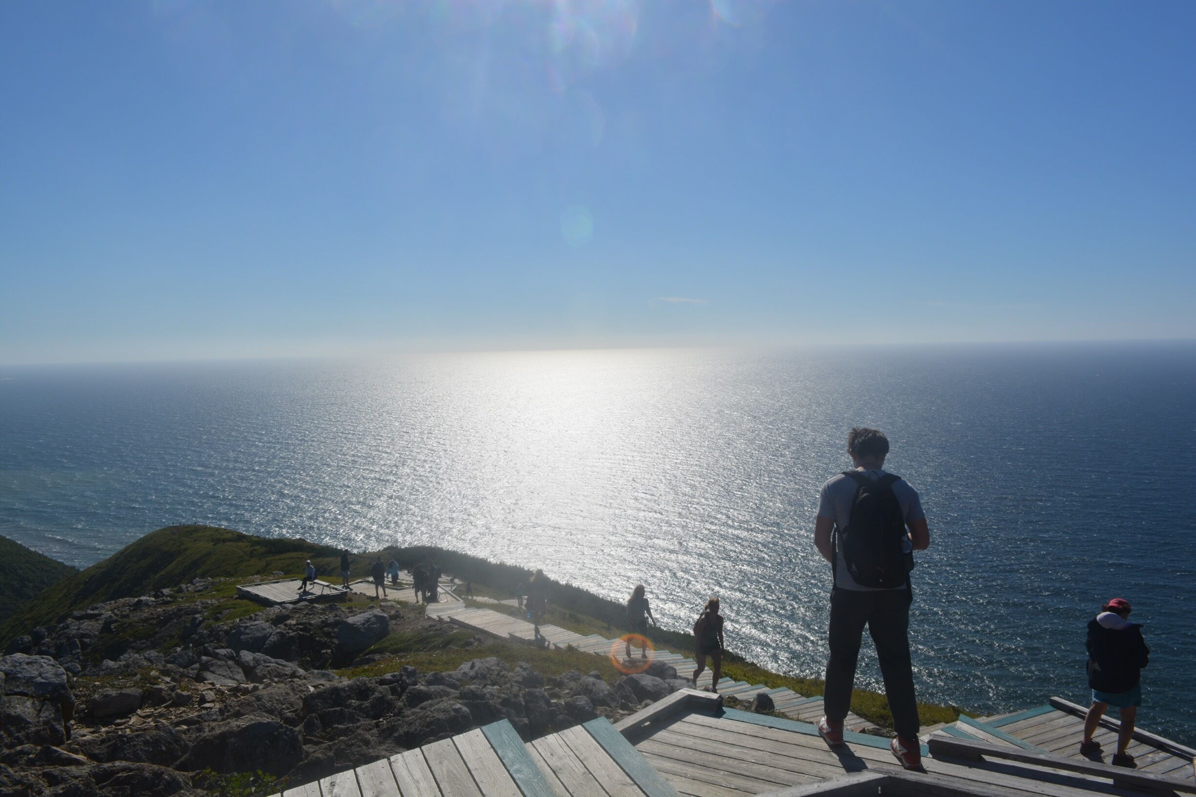 A coastal viewpoint with a wooden walkway overlooking the sea.