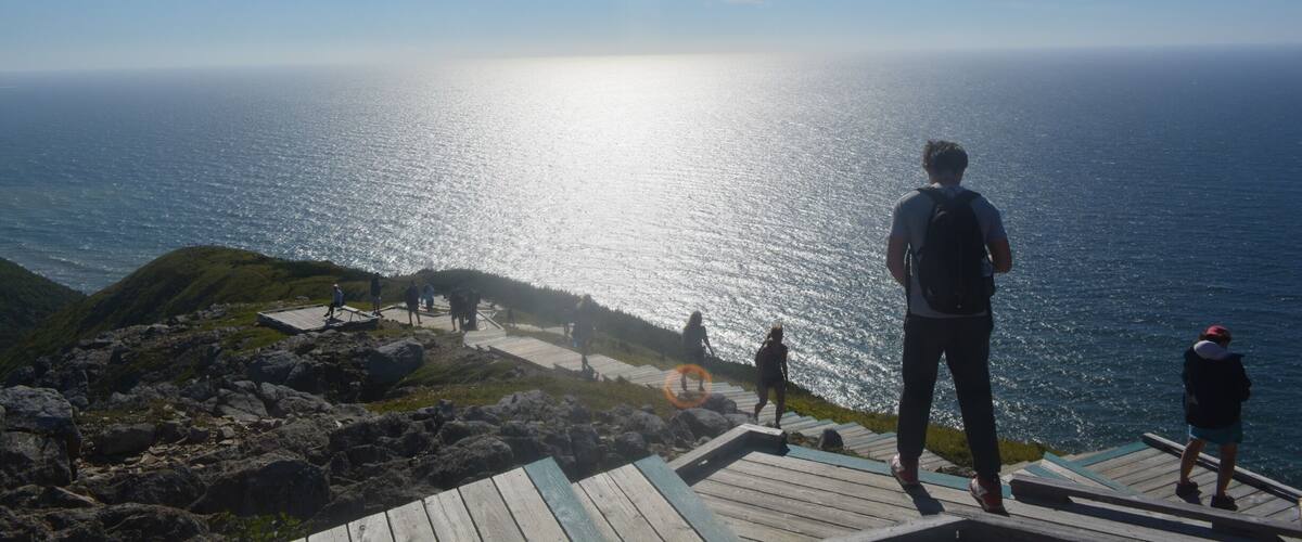 A coastal viewpoint with a wooden walkway overlooking the sea.
