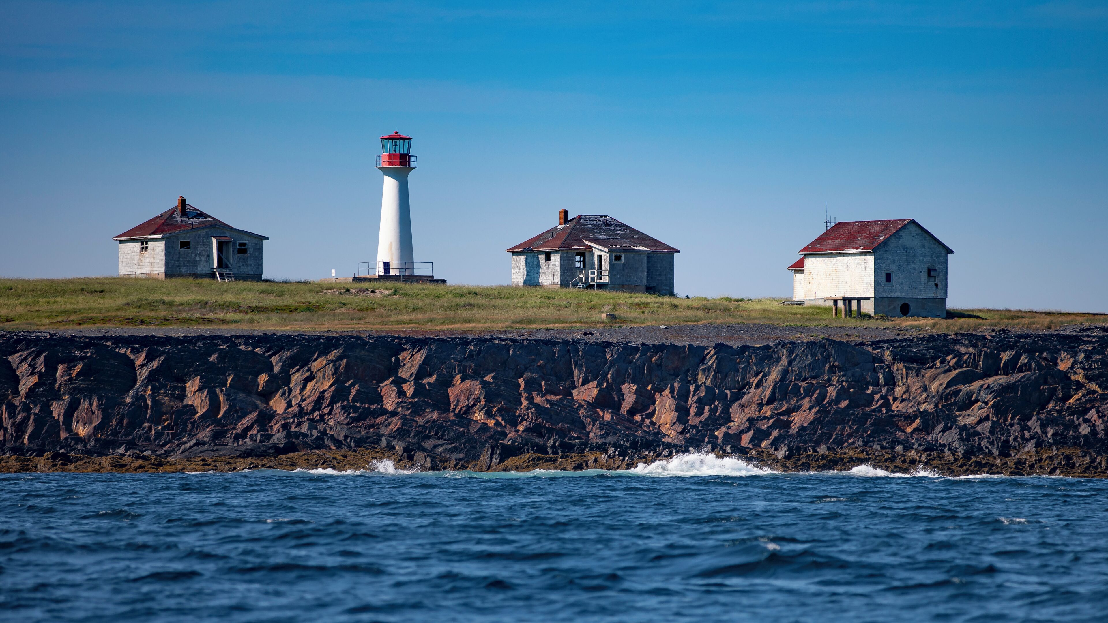 A wider view of the Cross Island Lighthouse, located in the North Atlantic Ocean, 8 miles Southeast of Lunenburg, NS