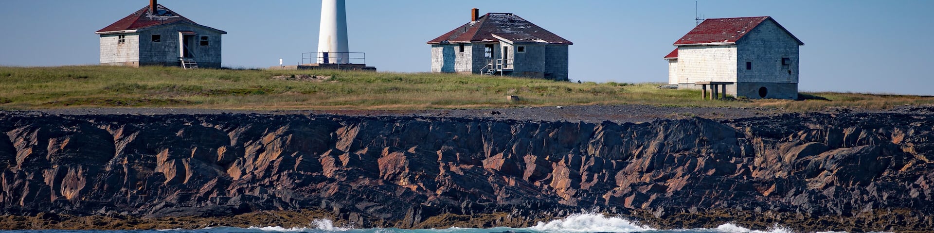 A wider view of the Cross Island Lighthouse, located in the North Atlantic Ocean, 8 miles Southeast of Lunenburg, NS