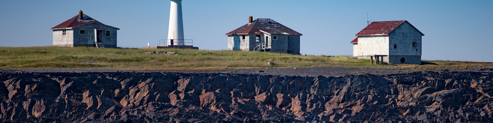 A wider view of the Cross Island Lighthouse, located in the North Atlantic Ocean, 8 miles Southeast of Lunenburg, NS