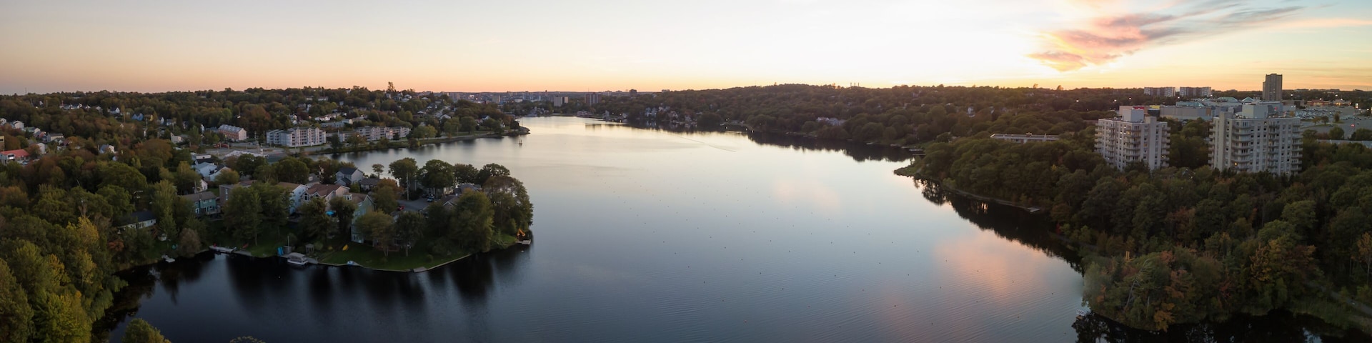 Aerial panoramic view of a Lake Banook in the Modern City during a vibrant Sunset. Taken in Halifax, Dartmouth, Nova Scotia, Canada.