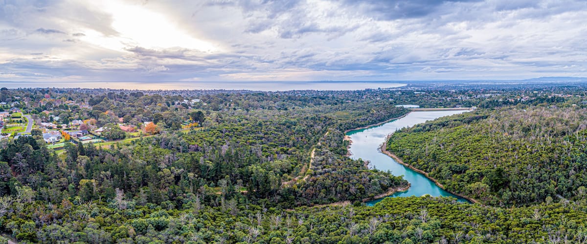 Wide aerial panorama of Frankston Reservoir with Port Phillip Bay on the horizon. Melbourne, Australia