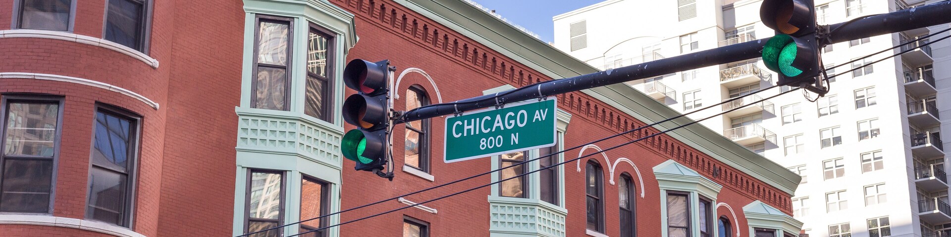 Chicago Ave. street sign in front of vintage building in uptown Chicago