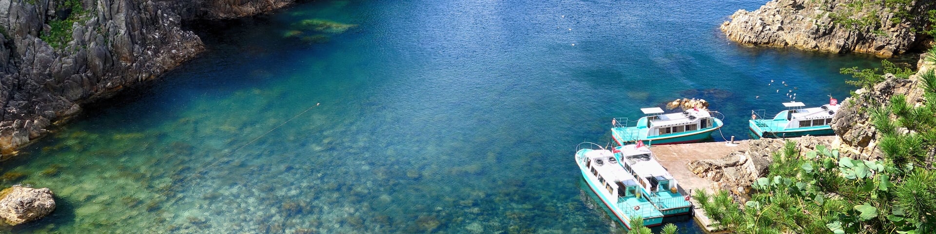 Boats docked at pier at the sea port in Sado island, Japan