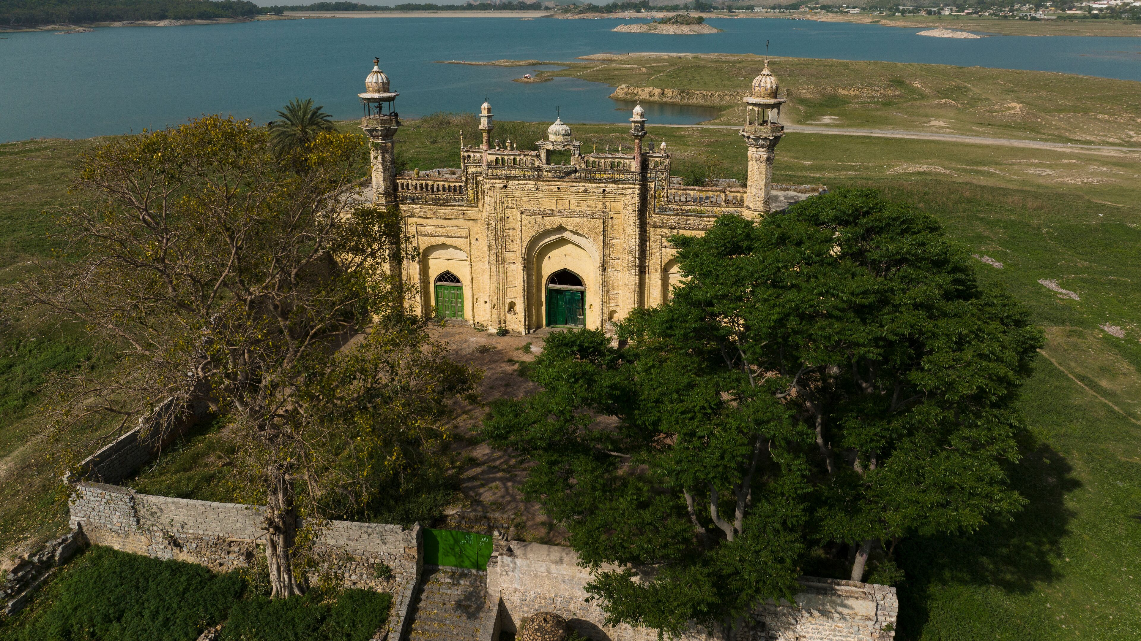 Aerial view of abandoned Mughal Mosque in the shore of Khanpur Dam, Islamabad, Pakistan