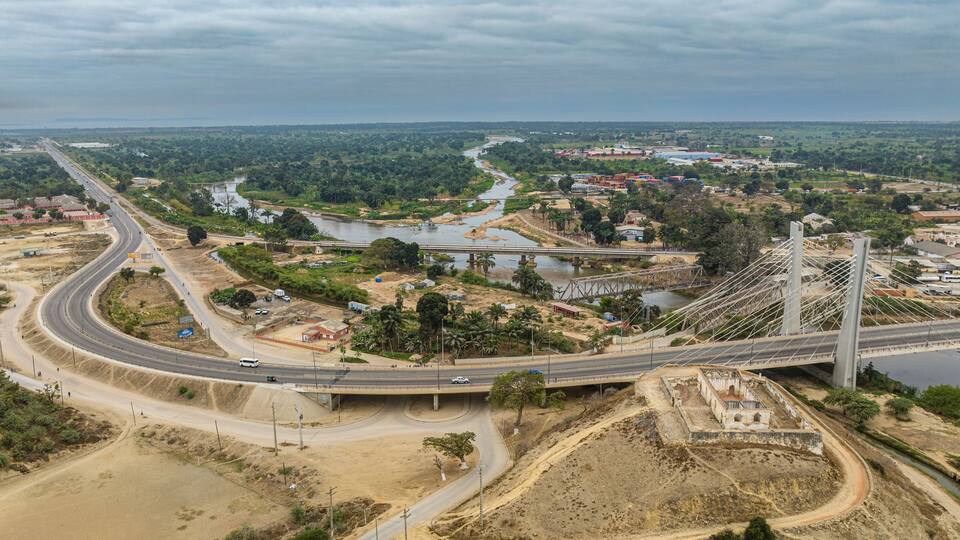 A bridge over a river, a highway, and a construction site.