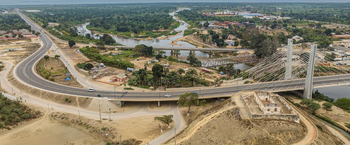 A bridge over a river, a highway, and a construction site.