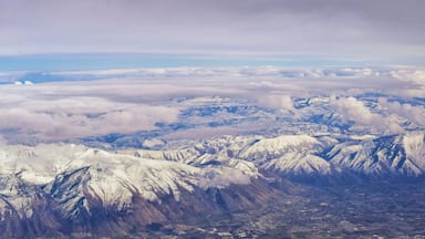 Aerial view from airplane of the Wasatch Front Rocky Mountain Range with snow capped peaks in winter including urban cities of Provo, Farmington Bountiful, Orem and Salt Lake City. Utah. United States