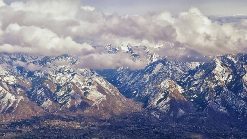 Snow-covered mountains with a town in the valley below.