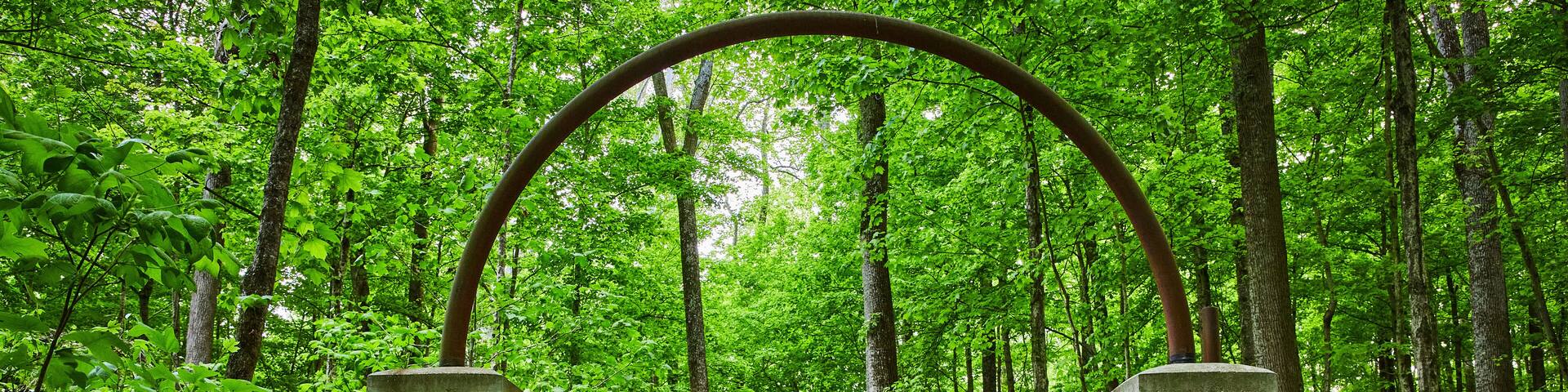 Walkway of roses, Rose Island park, forest, woodland, stone arches, archway, trail ending in woods