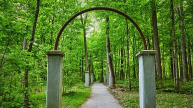 Walkway of roses, Rose Island park, forest, woodland, stone arches, archway, trail ending in woods