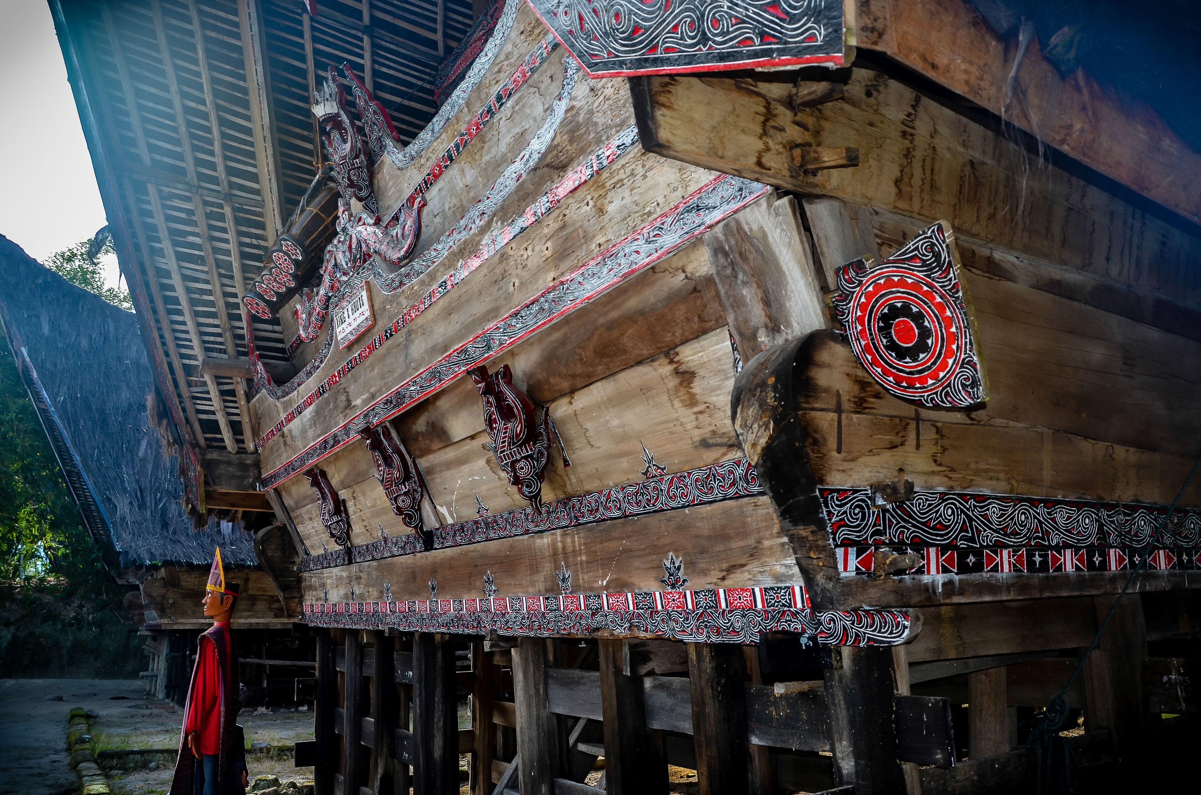 A traditional wooden boat with intricate carvings and decorations.