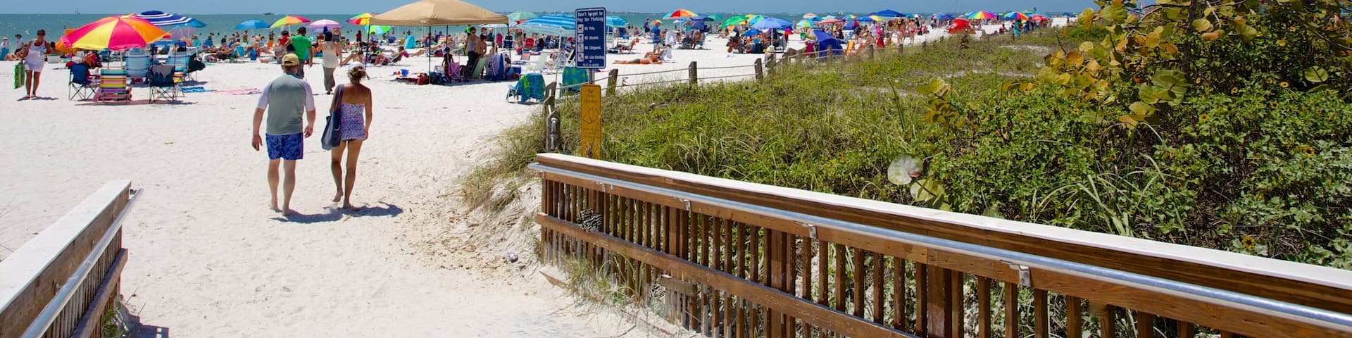 Fort Myers Beach showing a beach as well as a small group of people